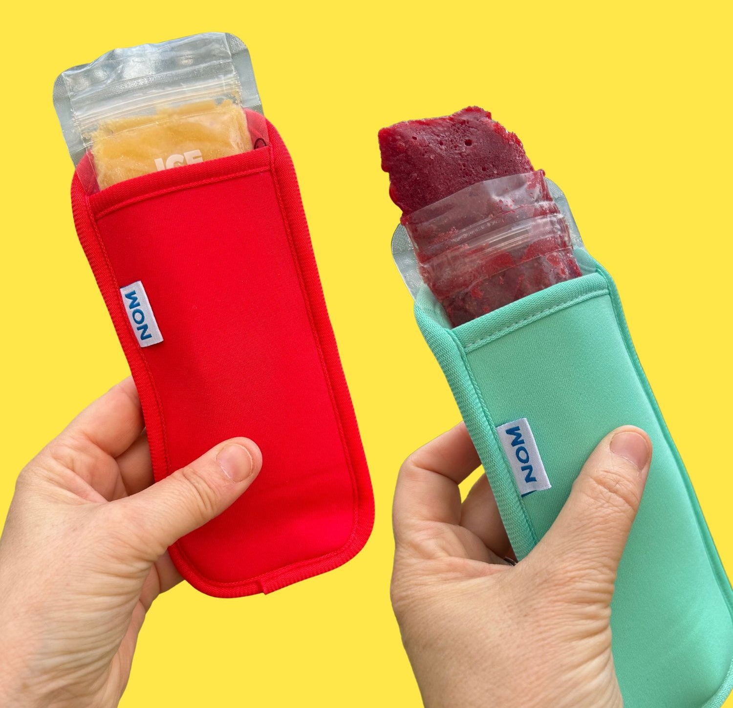Nom Nom kids reusable ice pops bags filled with homemade ice pop mixture covered by the Nom Nom kids reusable ice pop sleeves