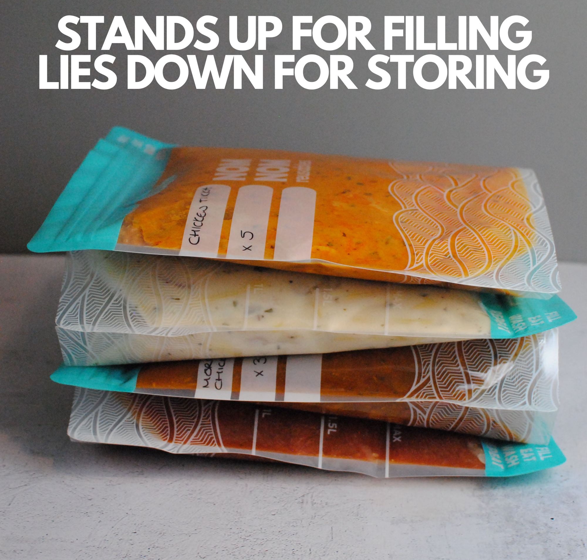 Nom Nom clear reusable freezer bags filed with food laying down for appropriate storage in the freezer