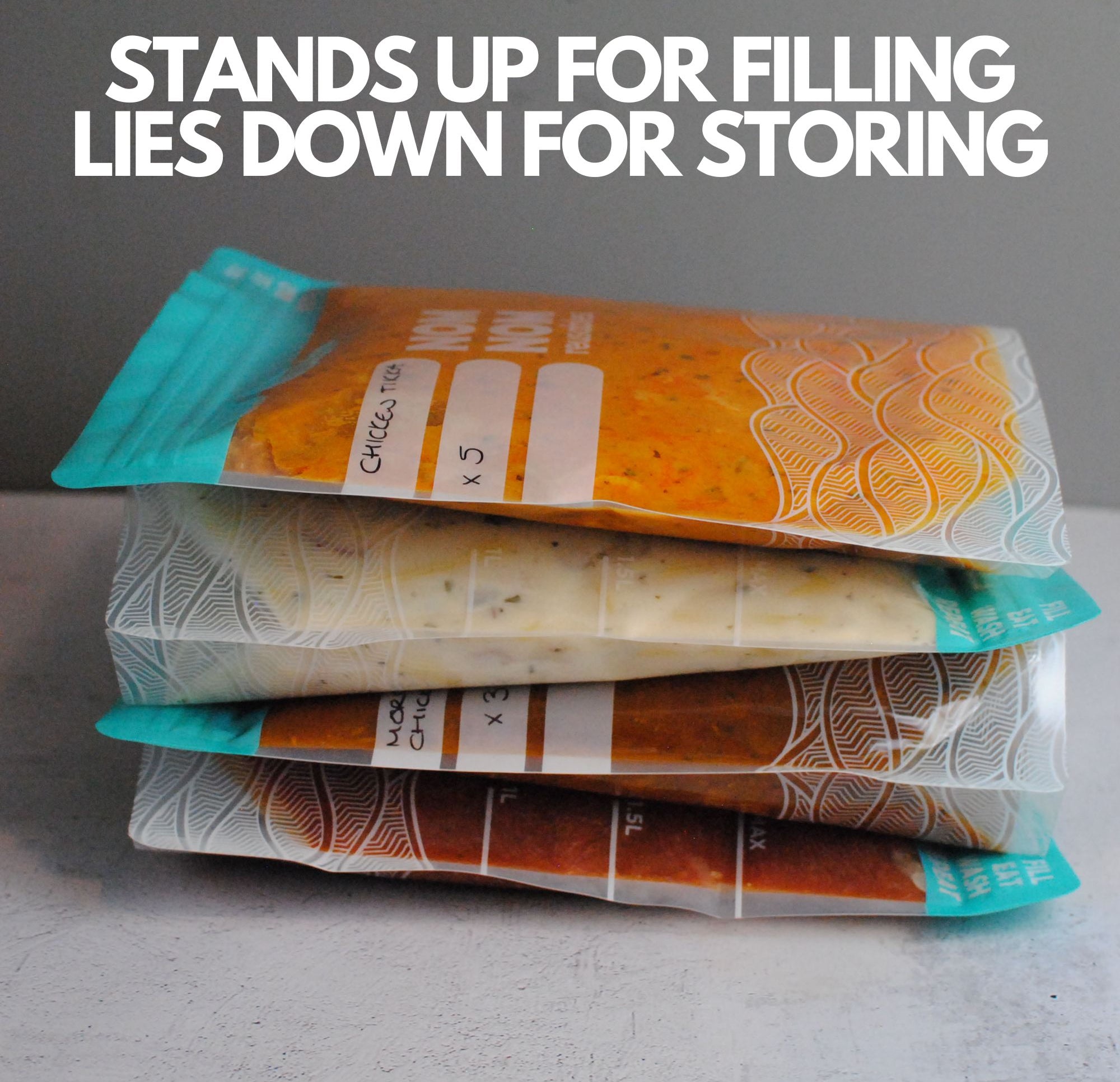 Nom Nom clear reusable freezer bags filed with food laying down for appropriate storage in the freezer