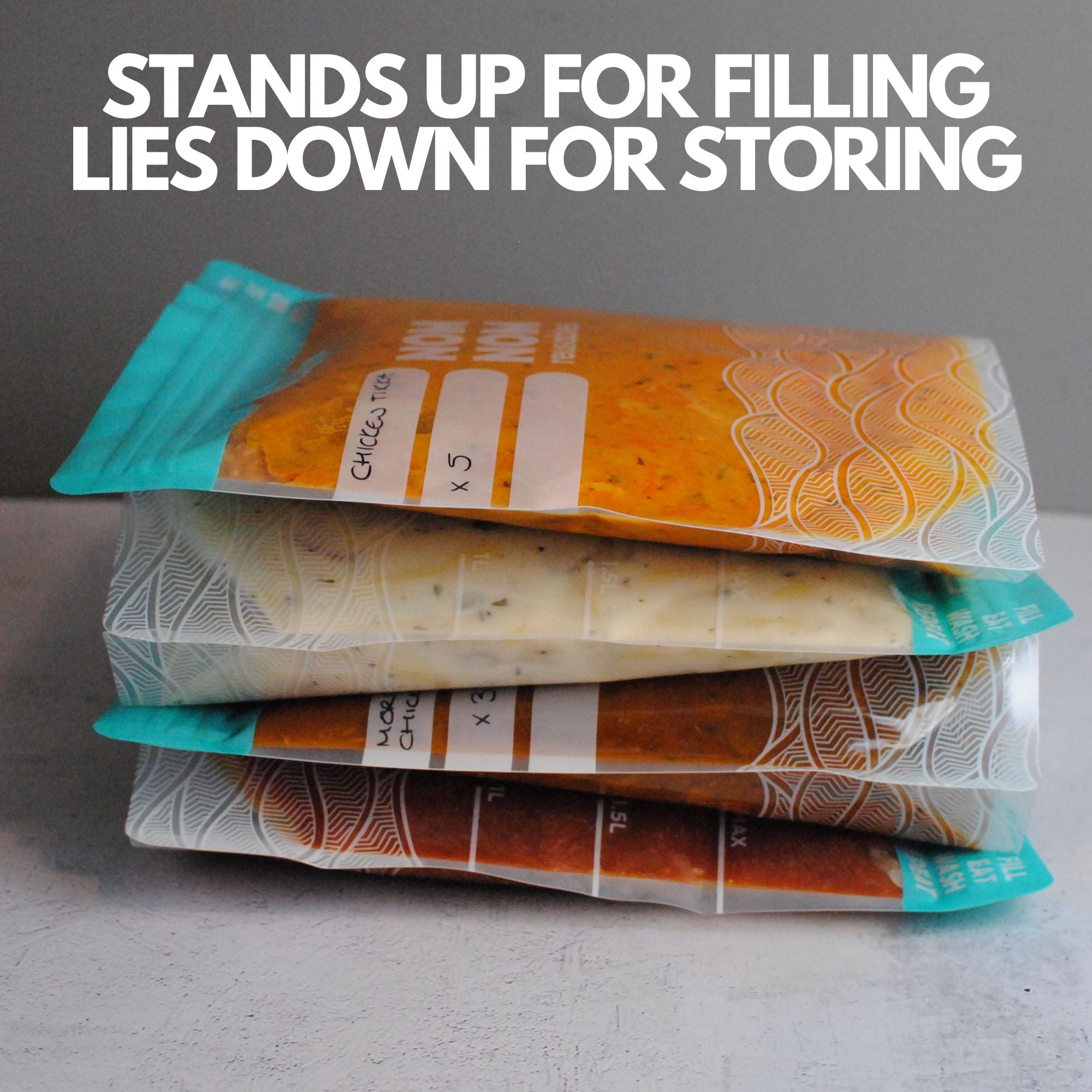 Nom Nom clear reusable freezer bags filed with food laying down for appropriate storage in the freezer