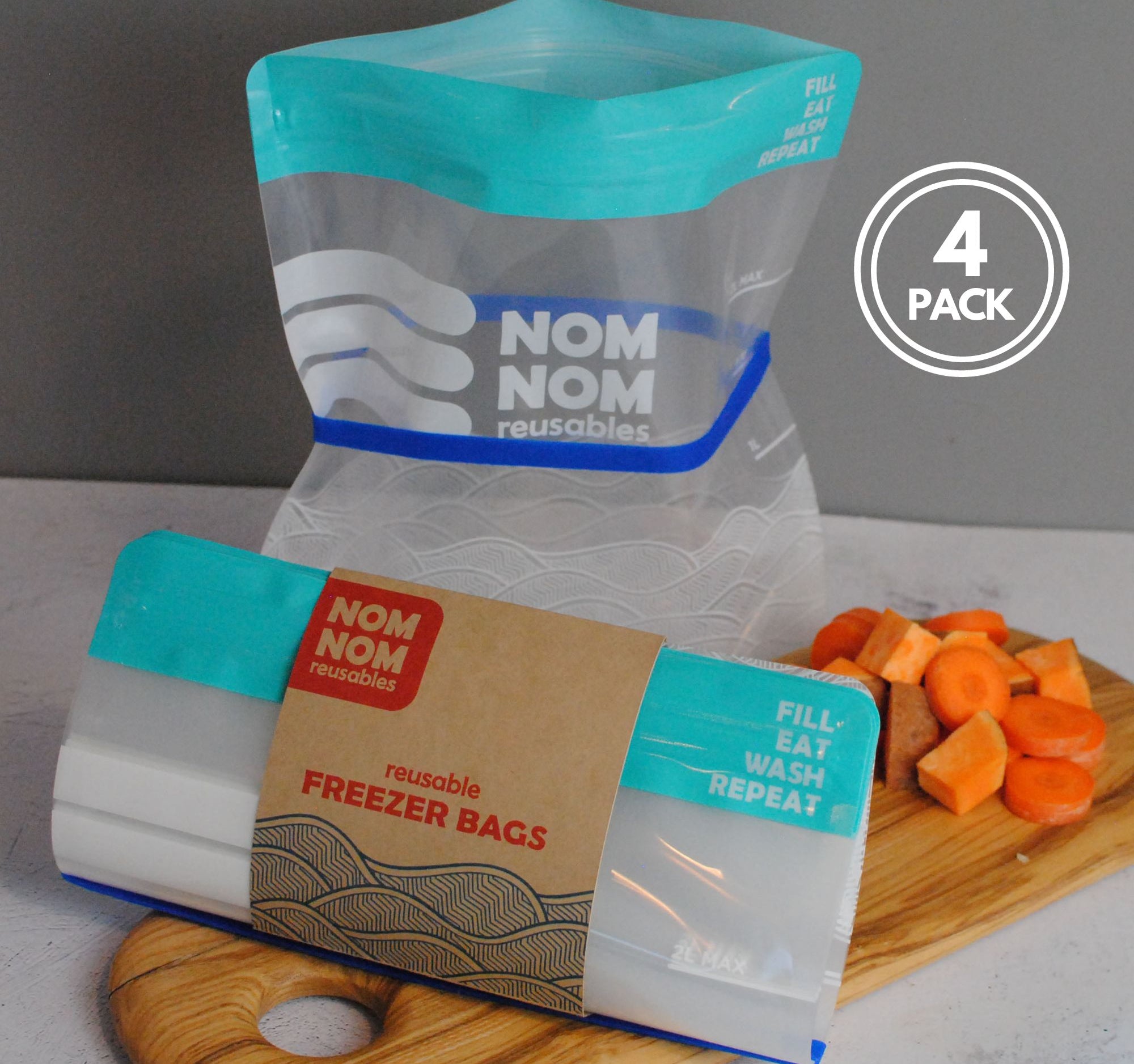 Nom Nom clear reusable freezer bags held open with a blue rubber band for easier filling
