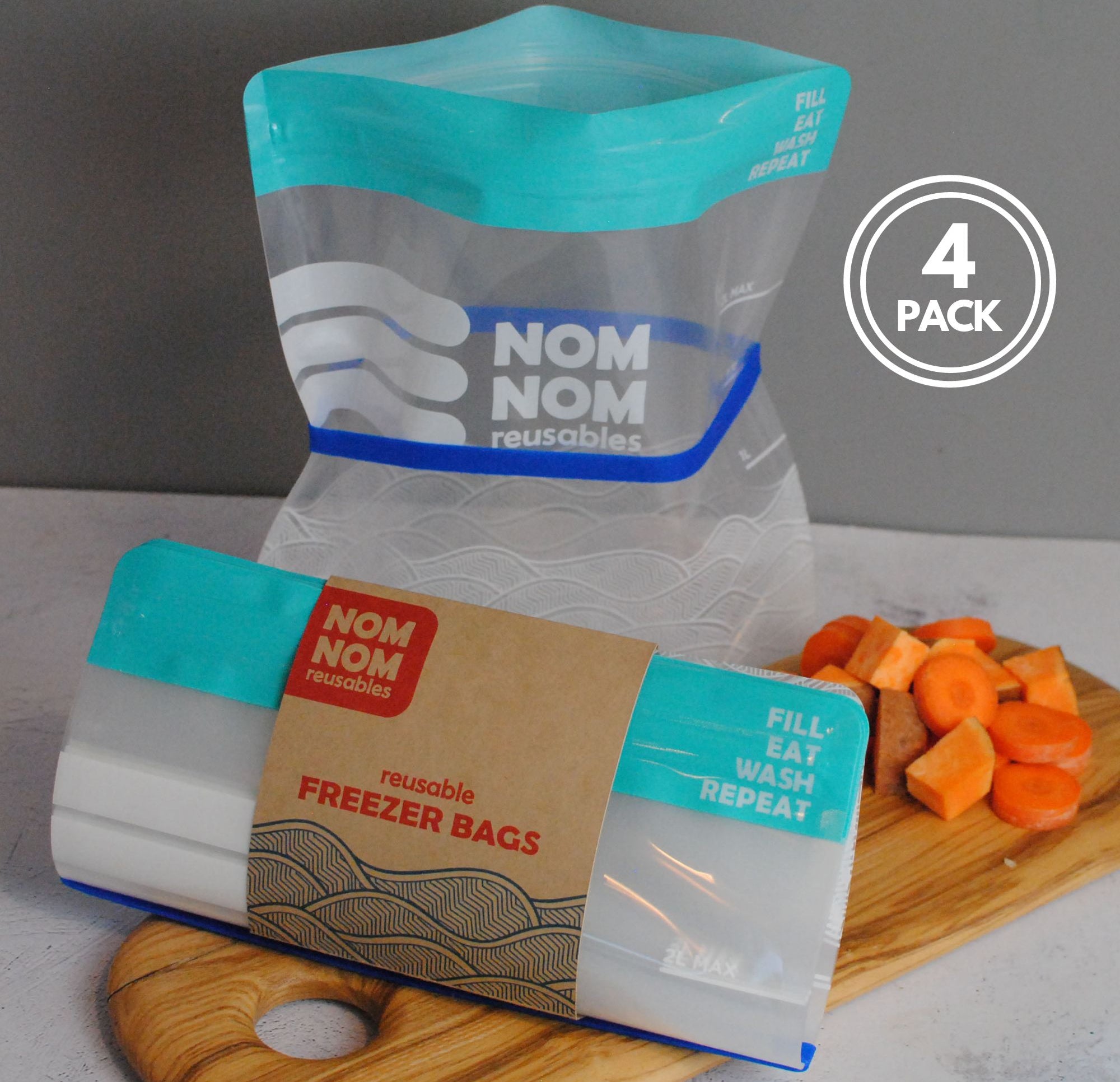 Nom Nom clear reusable freezer bags held open with a blue rubber band for easier filling