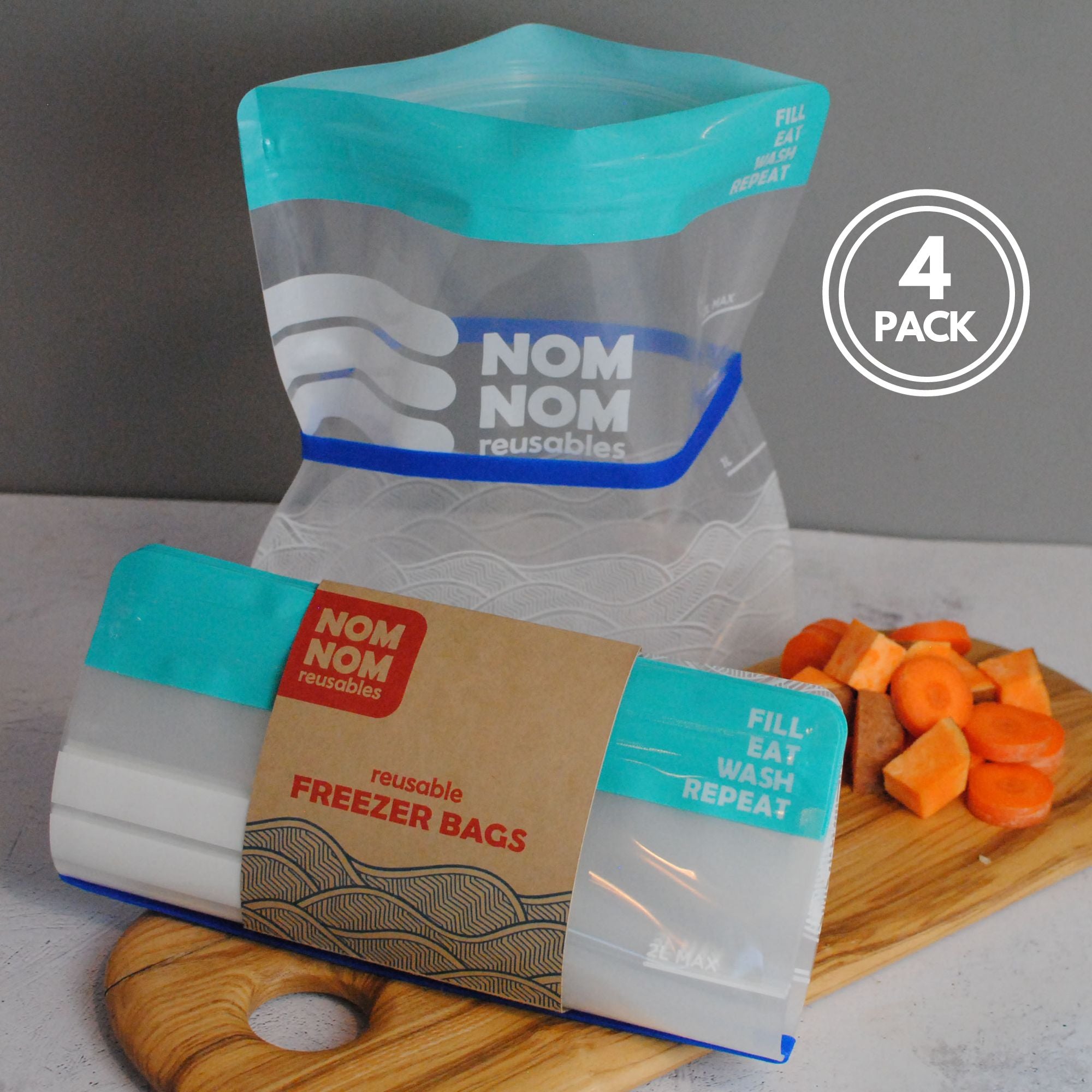 Nom Nom clear reusable freezer bags held open with a blue rubber band for easier filling