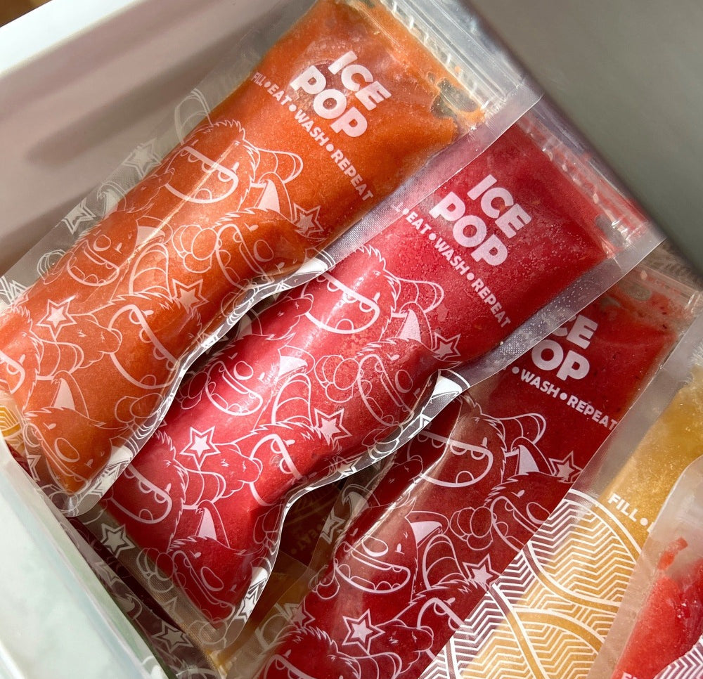 Nom Nom kids ice pop bags filled with homemade ice pop mixture packed into freezer