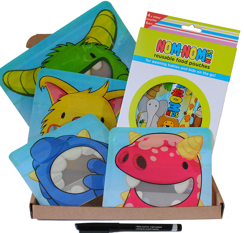 A set of reusable food pouches and snack bags with colorful monster designs, accompanied by a pen for labeling, displayed in a cardboard box.