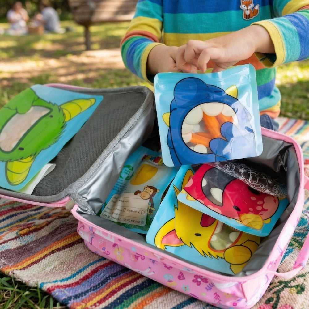 colourful picnic lunch in reusable bags with monster designs