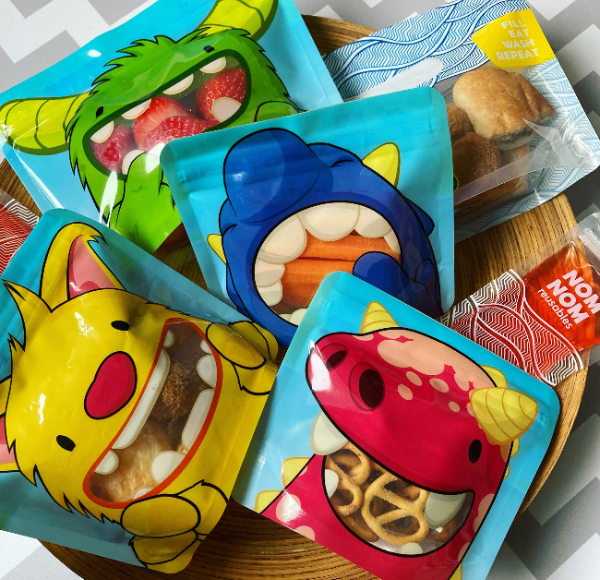 plate of snacks packed in brightly coloured reusable snack bags and sandwich bags