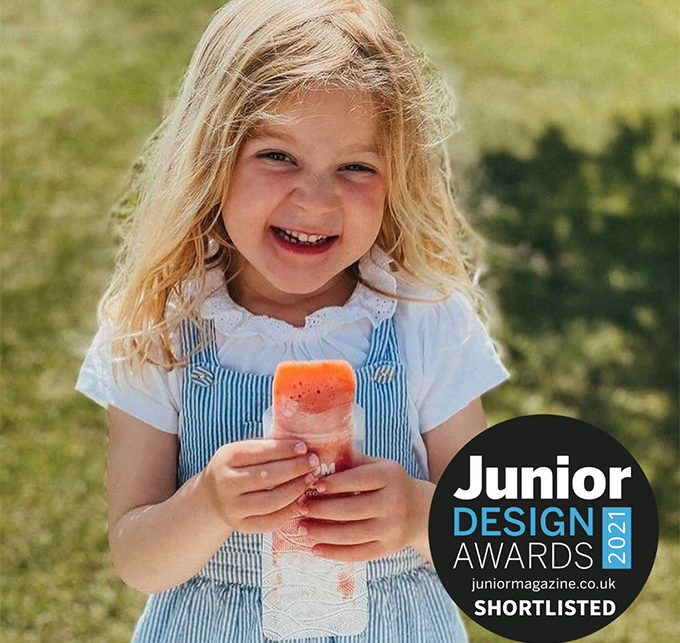 child eating an ice pop from a Nom Nom kids reusable ice pop bag
