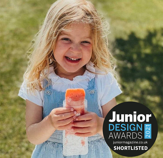 child eating an ice pop from a Nom Nom kids reusable ice pop bag