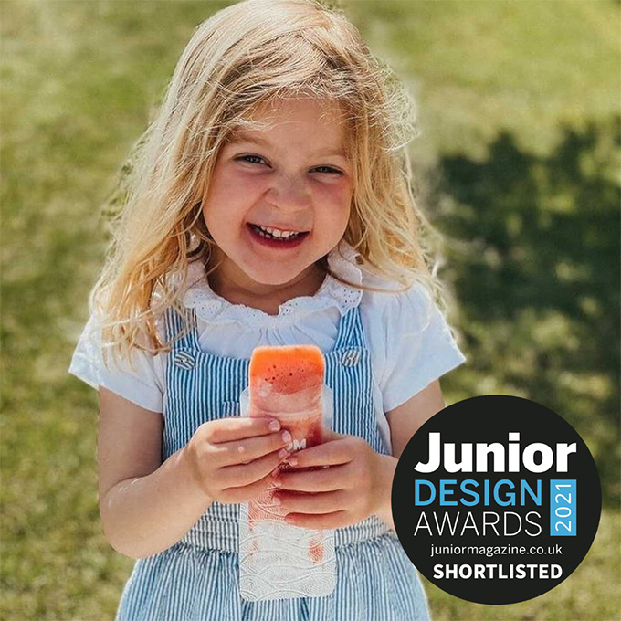 child eating an ice pop from a Nom Nom kids reusable ice pop bag