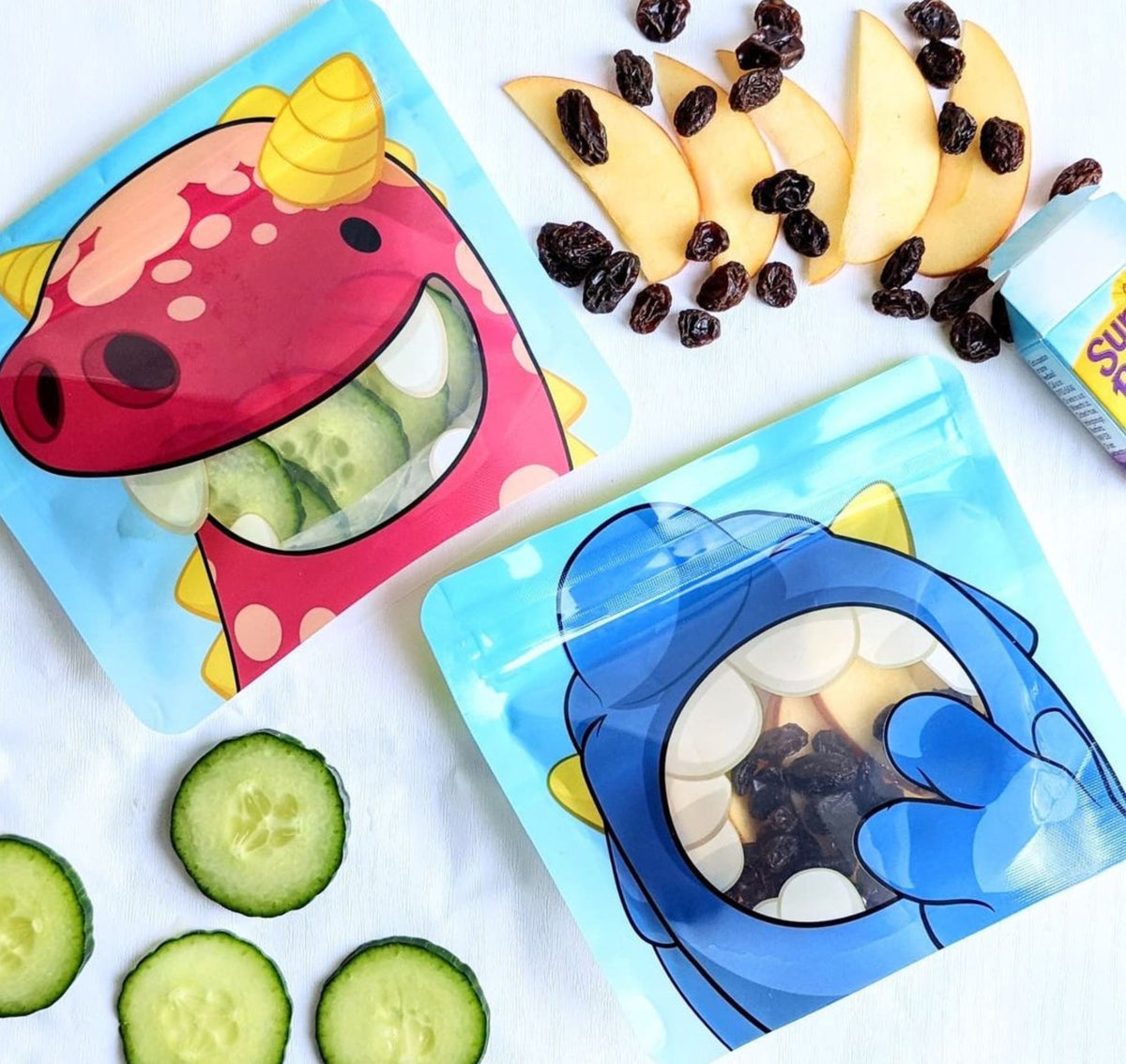 2 monster snack bags filled with fruit and veg lying on a kitchen work top