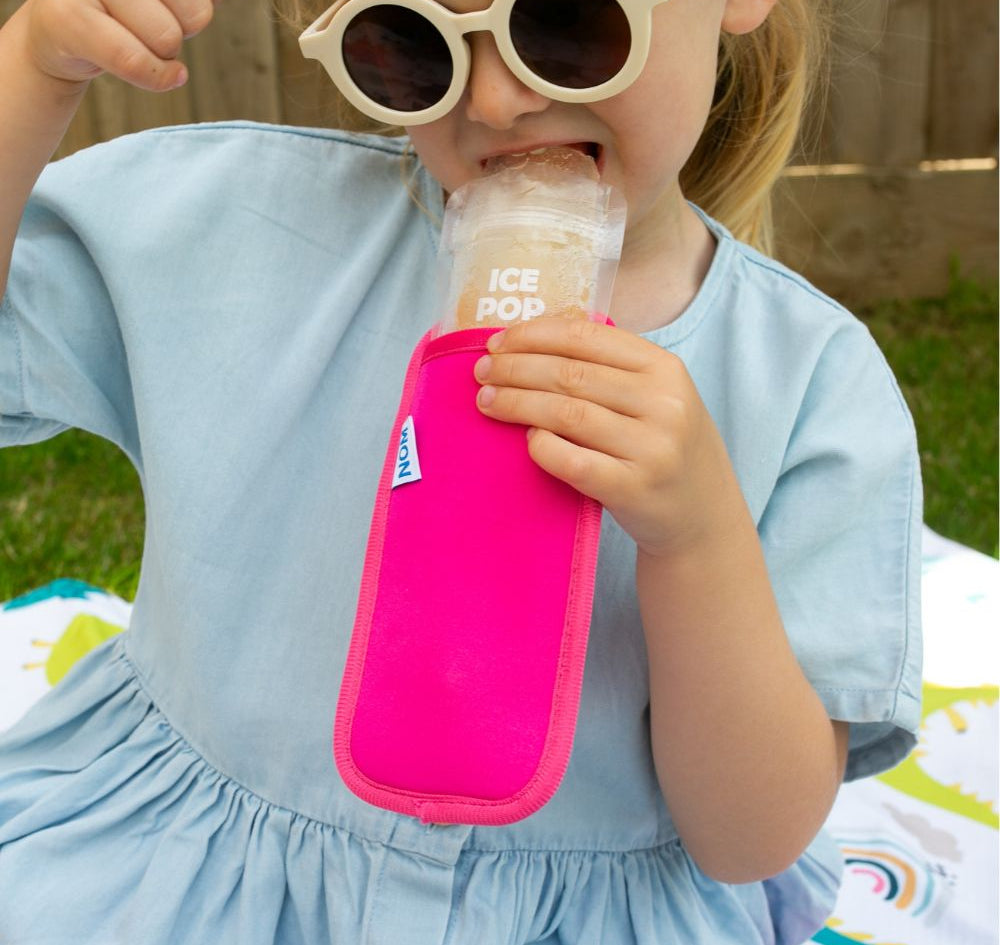Bright pink Neoprene ice pop sleeve for a Nom Nom reusable ice pop bag to stop hands from getting col and keep the ice pop from melting so quick