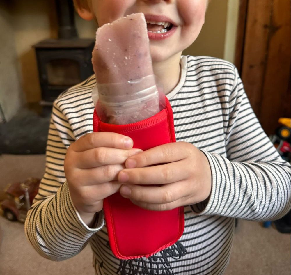 Red Neoprene ice pop sleeve for a Nom Nom reusable ice pop bag to stop hands from getting col and keep the ice pop from melting so quick
