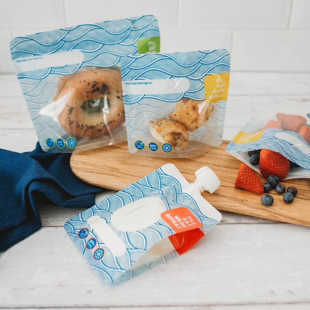 a lunch packed in reusable bags with a stylish blue and white wave design