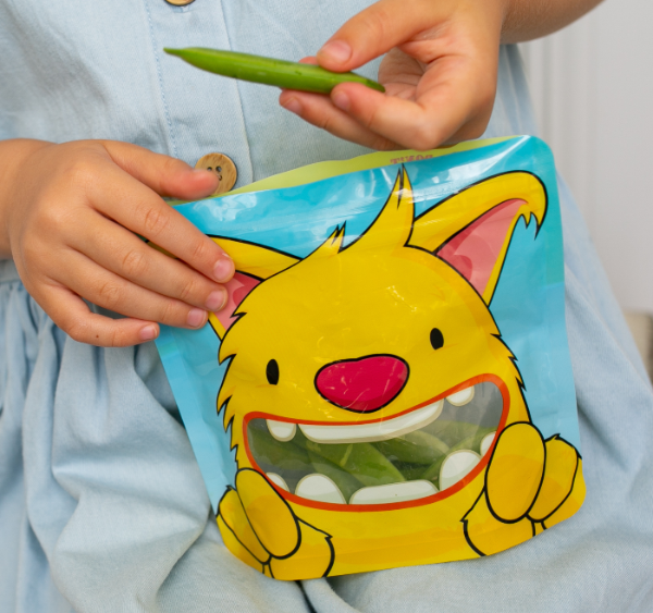 yellow monster snack bag filled with sugar snap peas