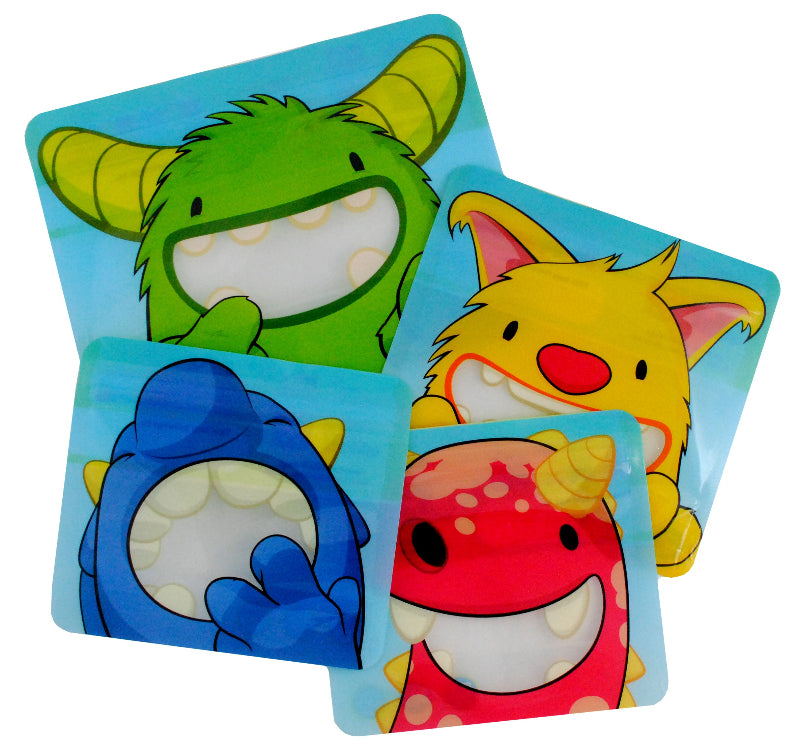 A set of four reusable snack bags with cartoon monster designs in green, yellow, blue, and red Nom Nom kids.