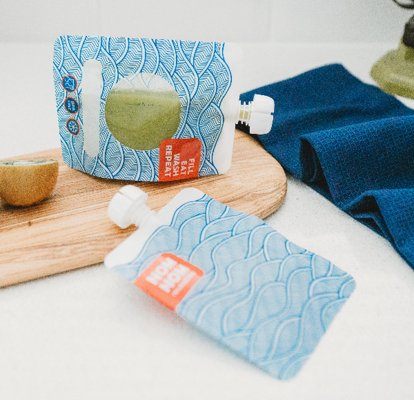 nom nom smoothie pouch filled with green smoothie