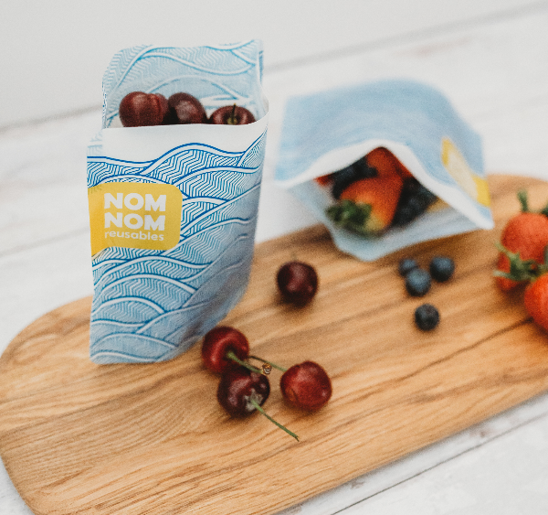 Nom Nom kids reusable sandwich bag filled with cherries.
