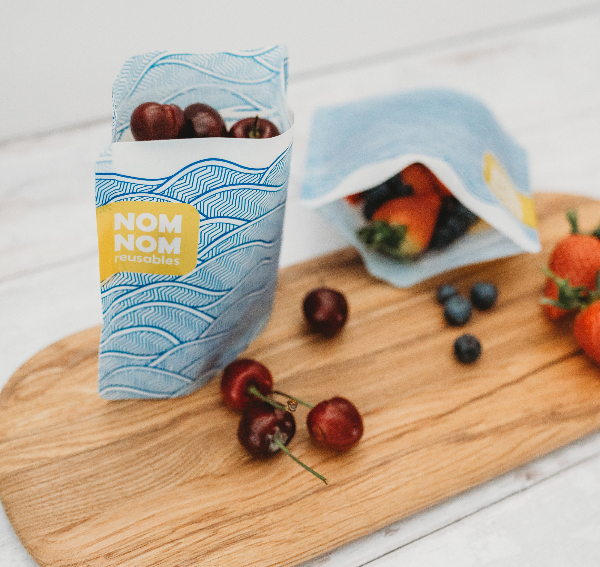 Nom Nom kids reusable sandwich bag filled with cherries.