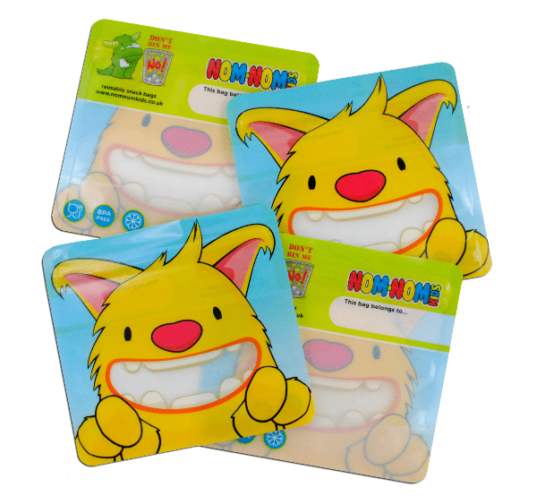 Four yellow reusable snack bags with a cartoon monster character on the front.