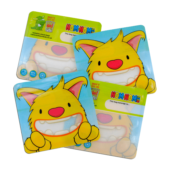 Four yellow reusable snack bags with a cartoon monster character on the front.