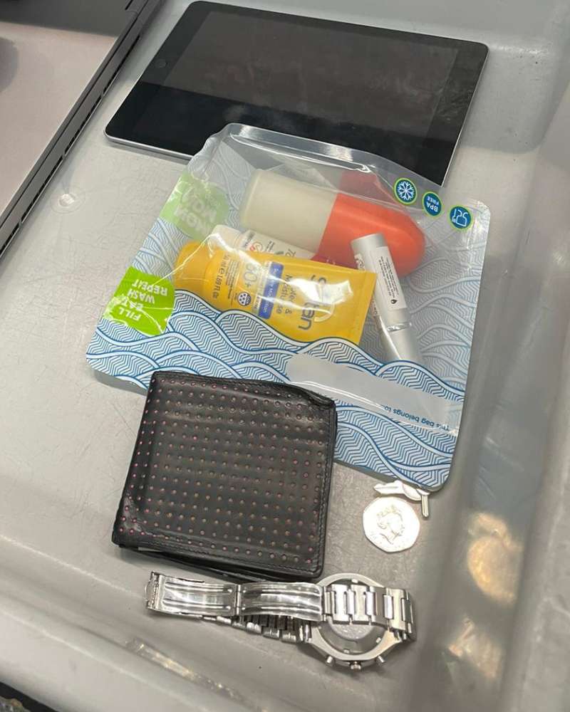 hand luggage items going through airline security checks including liquids in a Nom Nom Kids reusable Sandwich bag