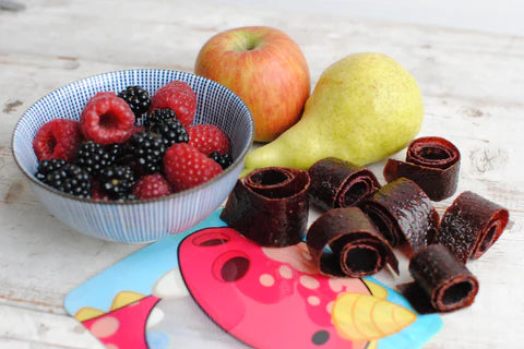 homemade fruit roll ups displayed on a Nom Nom kids reusable snack bag 
