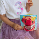 child eating flavoured rice cakes from a Nom Nom kids reusable snack pouch