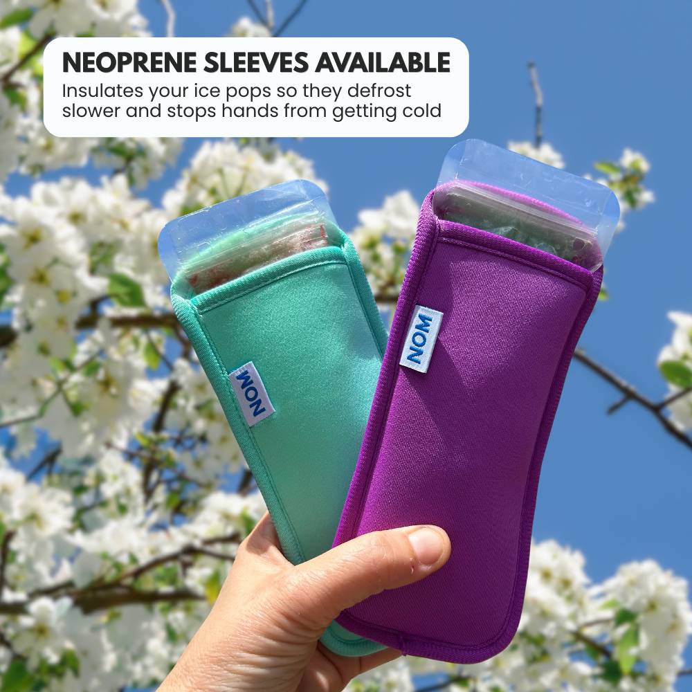 Two ice pop holders, one green and one purple, held by a hand with a cherry blossom background.