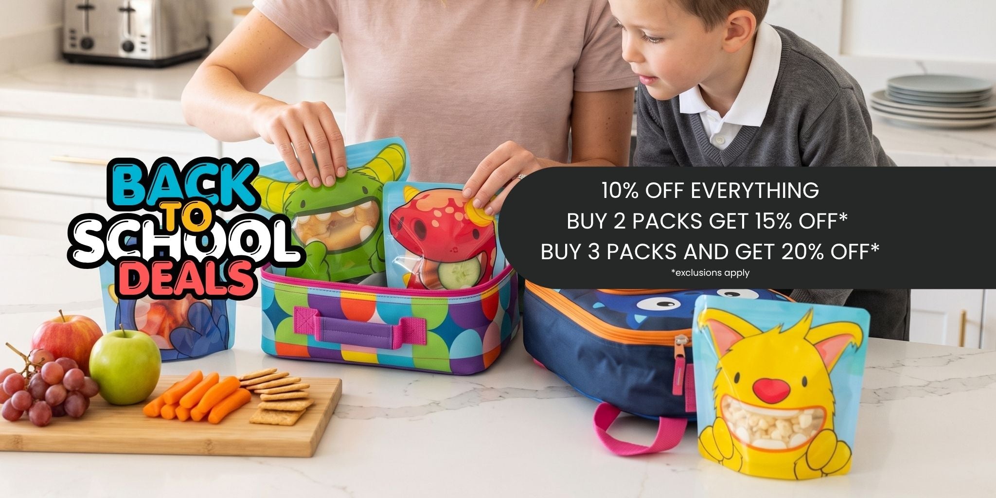 A family school lunch set displayed on a kitchen counter, featuring a colorful lunchbox, a blue backpack, and a yellow monster snack bag. A woman and a boy are seen packing the lunchbox, with promotional text overlays for 'Back to School Deals'.