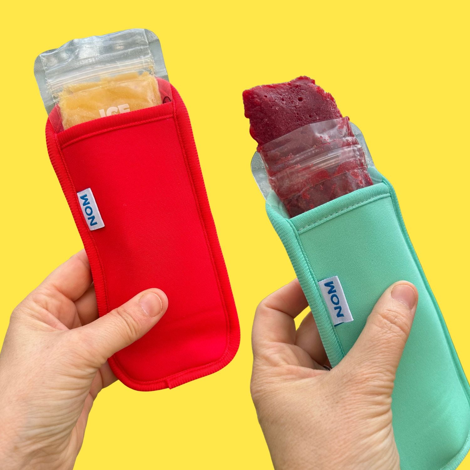 Nom Nom kids reusable ice pops bags filled with homemade ice pop mixture covered by the Nom Nom kids reusable ice pop sleeves 