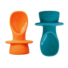 Two silicone baby pouch spoon products on a white background. one is orange and one is teal blue in colour.