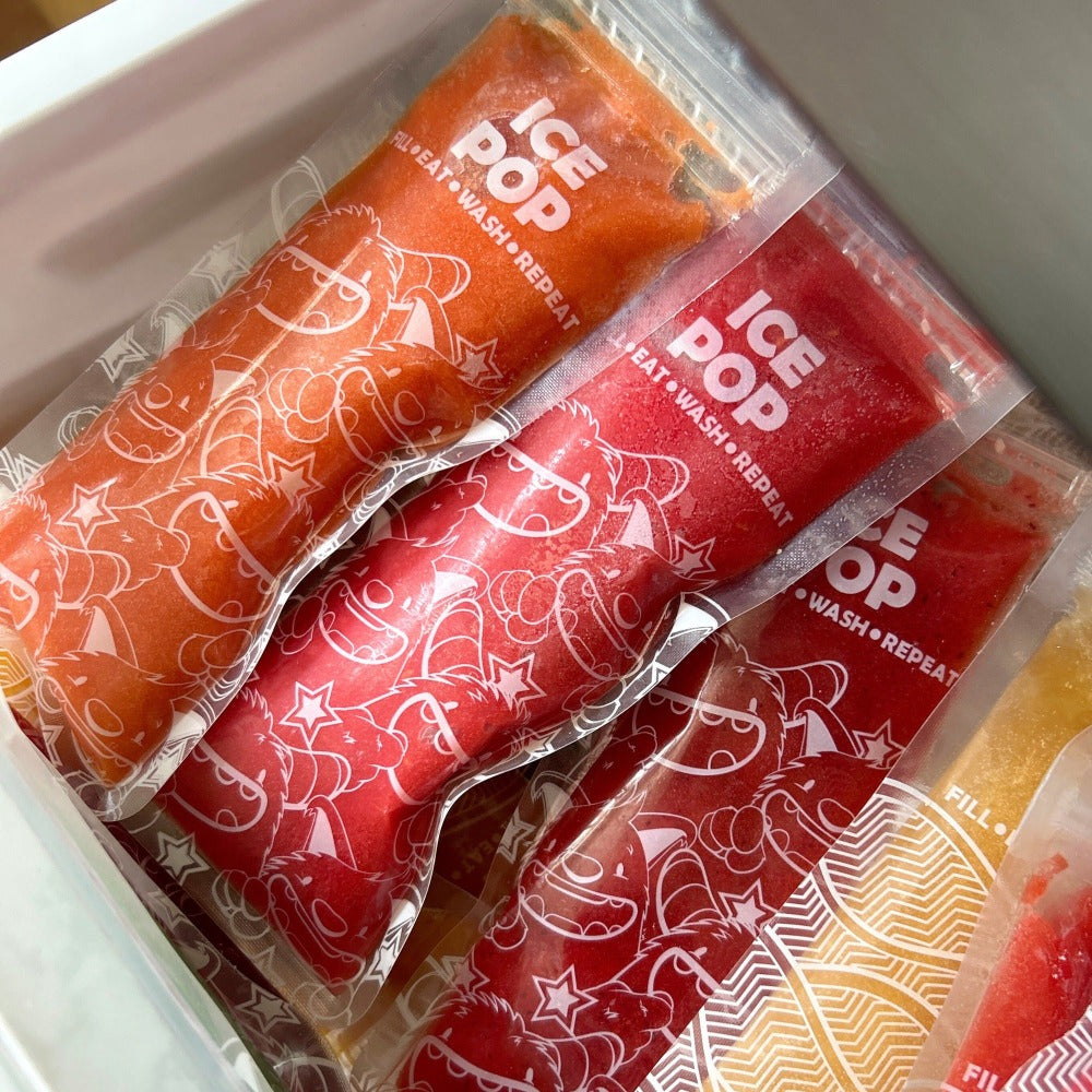 Nom Nom kids ice pop bags filled with homemade ice pop mixture packed into freezer 