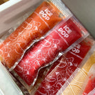 Nom Nom kids ice pop bags filled with homemade ice pop mixture packed into freezer 