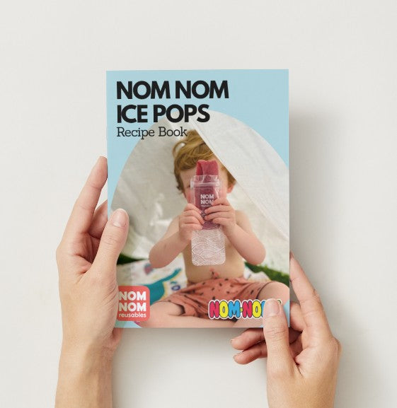the nom nom kids ice pop recipe book held in a womans hand