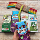 Nom Nom kids reusable silicone straws presented with various juice boxes. 