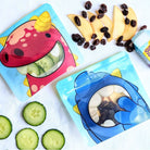 Nom Nom kids reusable snack pouches with cucumbers and apples with raisins. 