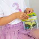child eating from a Nom Nom kids reusable snack bag