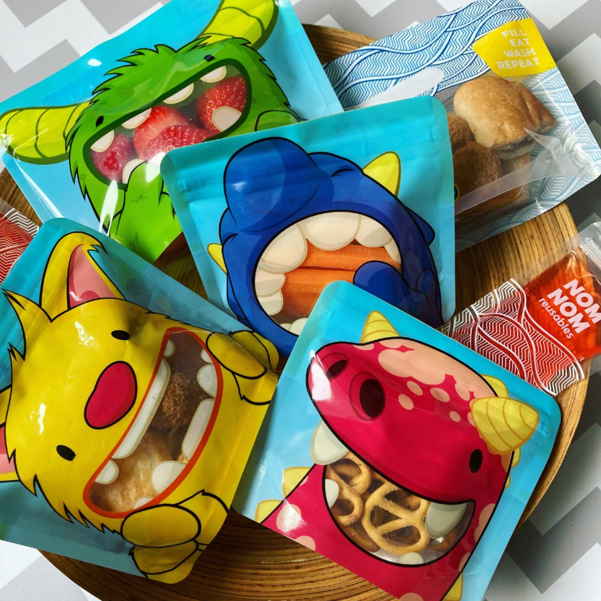 Nom Nom kids reusable snack monster pouches filled with various snacks 
