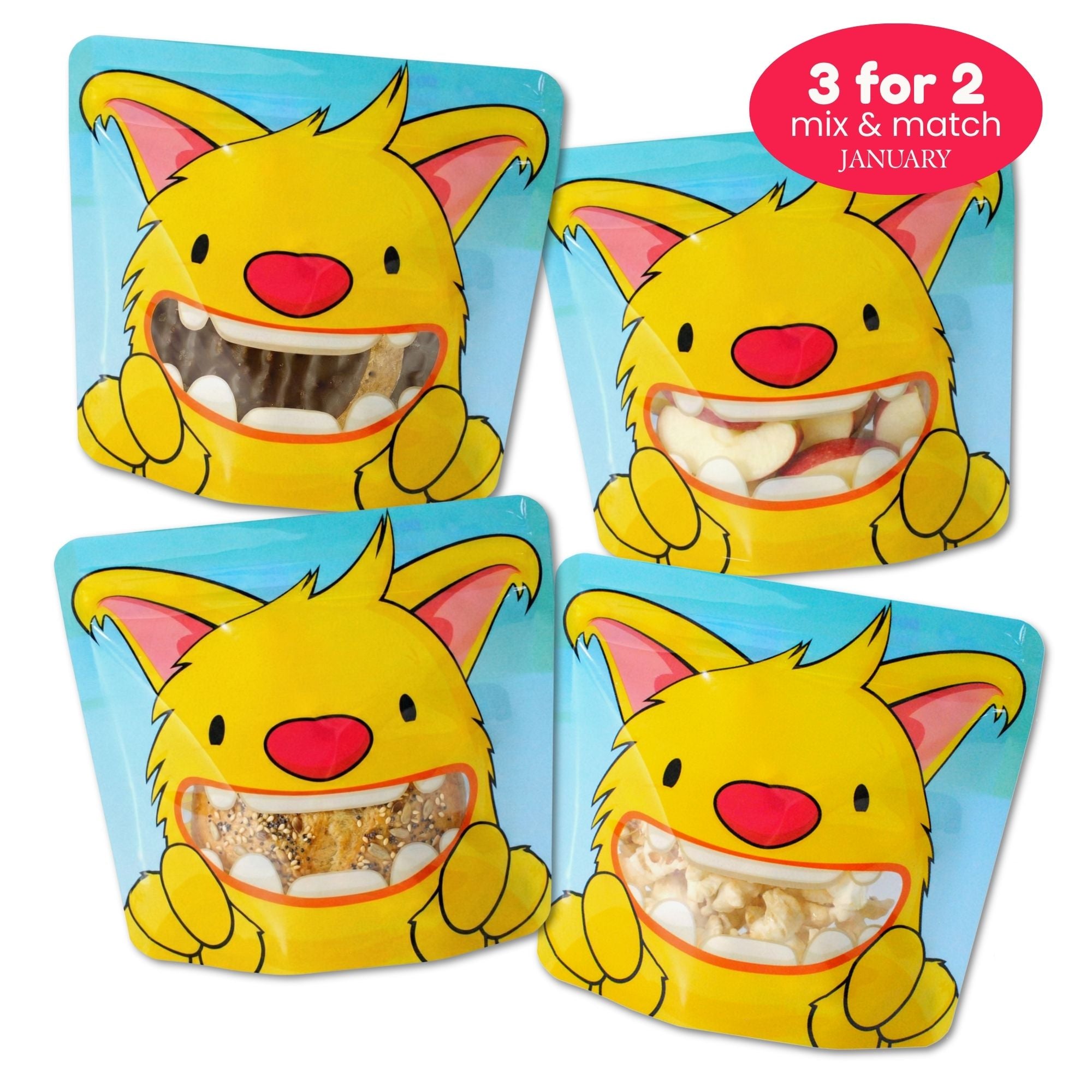 yellow monster snack bags holding different snack fillings of popcorn, biscuits, apple slices and a seeded sandwich roll