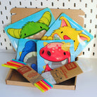 box of Nom Nom Kids products containing silicone straws, reusable ice pop bags and monster reusable snack bags