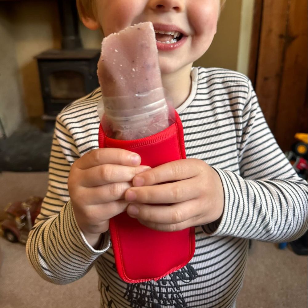 Red Neoprene ice pop sleeve for a Nom Nom reusable ice pop bag to stop hands from getting col and keep the ice pop from melting so quick