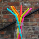 rainbow coloured silicone straws in a bottle