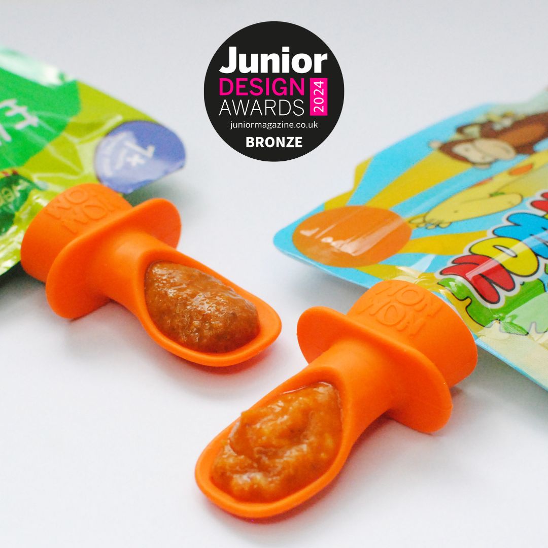 2 silicone pouch spoons. 1 attached to an Ella's Kitchen pouch and 1 attached to a Nom Nom Kids pouch with a Junior design award badge
