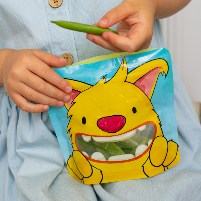 yellow monster snack bag filled with sugar snap peas