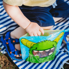 baby reaching inside Nom Nom kids reusable sandwich bag 