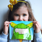 little girl holding Nom Nom kids sandwich bag 
