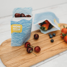 Nom Nom kids reusable sandwich bag filled with cherries.